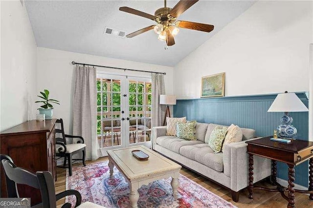 374 Dooley Rd, Dallas, GA 30132 - living room with vaulted ceiling, ceiling fan, wood finished floors, french doors, and wainscoting