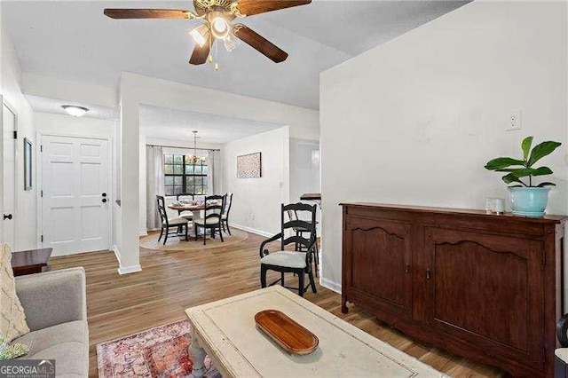 374 Dooley Rd, Dallas, GA 30132 - living area featuring a ceiling fan, baseboards, light wood-type flooring, and a chandelier