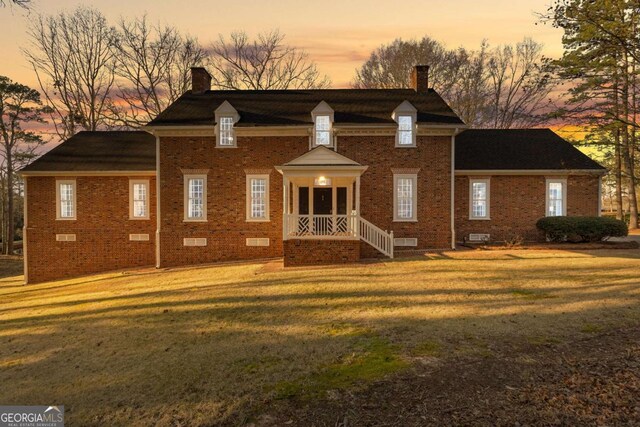 135 Mill Race Rd, Thomaston, GA 30286 - view of front of house featuring a chimney, brick siding, a front lawn, and crawl space