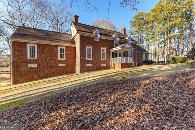 135 Mill Race Rd, Thomaston, GA 30286 - back of house with brick siding, a chimney, crawl space, and a lawn