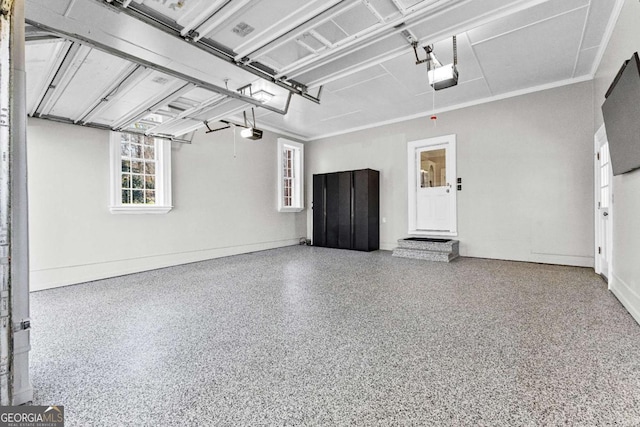 135 Mill Race Rd, Thomaston, GA 30286 - garage featuring a garage door opener and baseboards