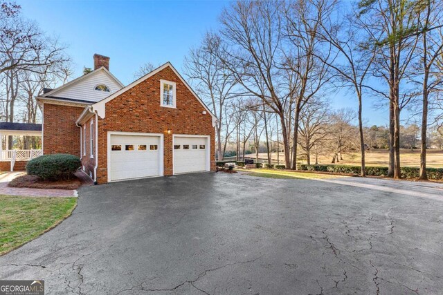 135 Mill Race Rd, Thomaston, GA 30286 - view of property exterior featuring a chimney, brick siding, and driveway