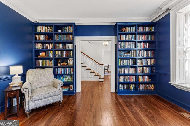 135 Mill Race Rd, Thomaston, GA 30286 - living area featuring wood-type flooring, ornamental molding, stairs, and bookshelves