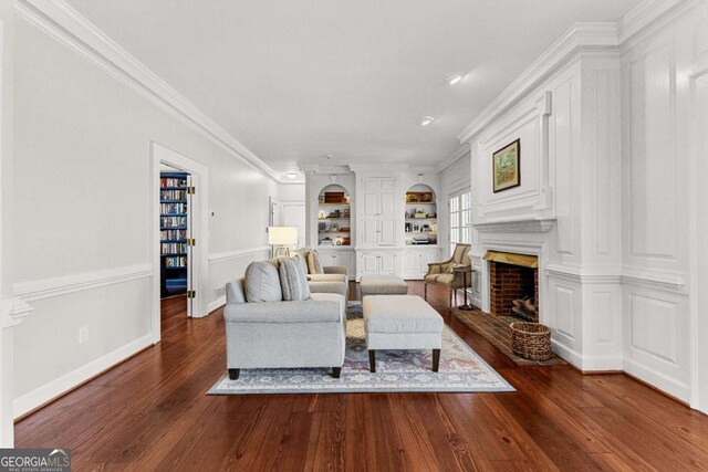 135 Mill Race Rd, Thomaston, GA 30286 - living room with dark wood-style flooring, a fireplace, crown molding, built in features, and recessed lighting