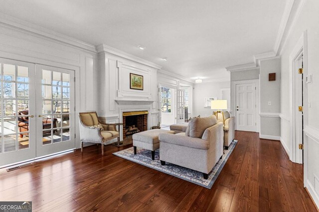 135 Mill Race Rd, Thomaston, GA 30286 - living room featuring french doors, ornamental molding, dark wood finished floors, and a fireplace
