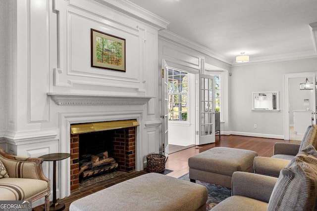 135 Mill Race Rd, Thomaston, GA 30286 - living area with ornamental molding, a brick fireplace, baseboards, and wood finished floors