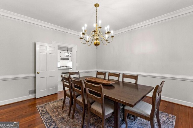 135 Mill Race Rd, Thomaston, GA 30286 - dining area featuring a chandelier, ornamental molding, dark wood-style flooring, and baseboards