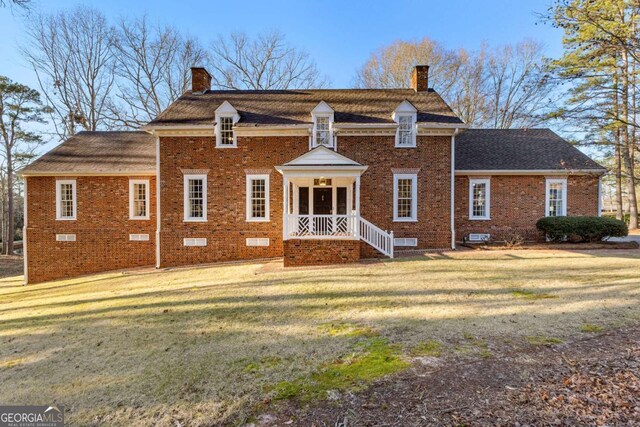 135 Mill Race Rd, Thomaston, GA 30286 - view of front of home with a chimney, brick siding, and a front yard