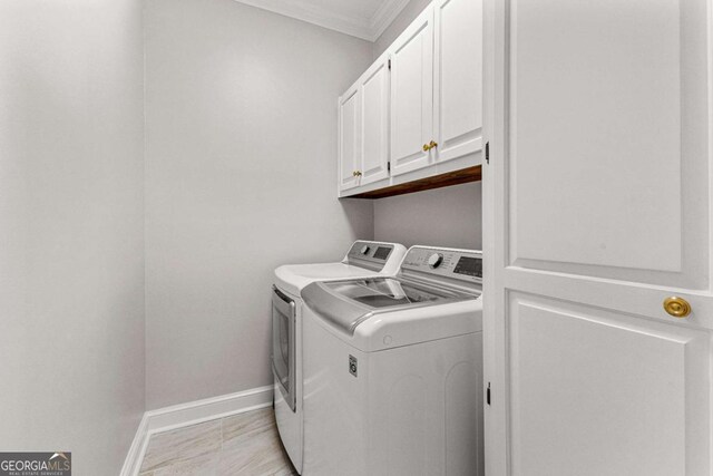 135 Mill Race Rd, Thomaston, GA 30286 - laundry room with washing machine and clothes dryer, cabinet space, crown molding, and baseboards