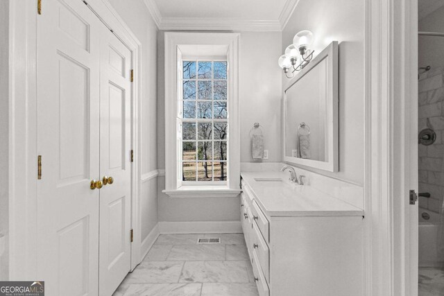 135 Mill Race Rd, Thomaston, GA 30286 - bathroom with marble look tile flooring, vanity, ornamental molding, healthy amount of natural light, and baseboards