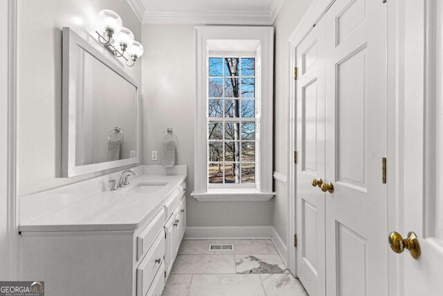 135 Mill Race Rd, Thomaston, GA 30286 - bathroom with baseboards, vanity, crown molding, and marble finish floors