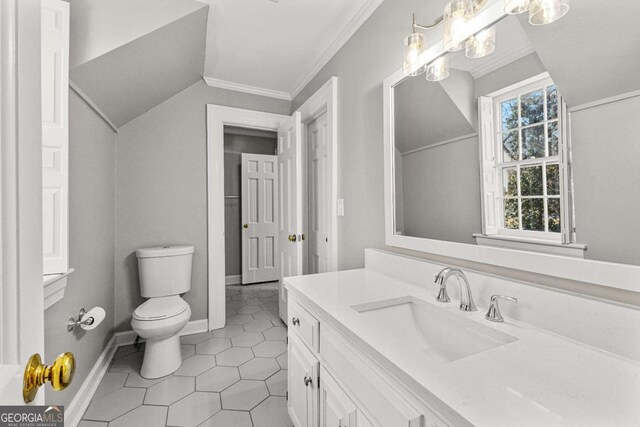 135 Mill Race Rd, Thomaston, GA 30286 - bathroom featuring toilet, vanity, crown molding, vaulted ceiling, and tile patterned floors