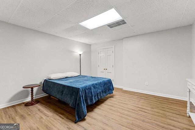135 Mill Race Rd, Thomaston, GA 30286 - bedroom with wood finished floors, baseboards, and a drop ceiling