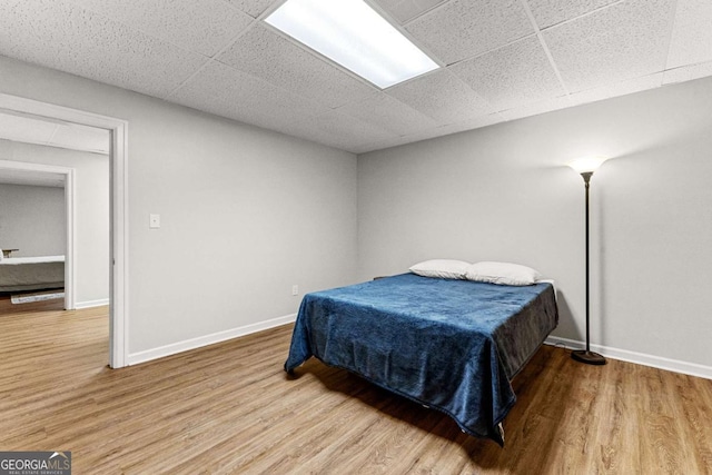 135 Mill Race Rd, Thomaston, GA 30286 - bedroom with wood finished floors, baseboards, and a drop ceiling