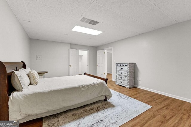 135 Mill Race Rd, Thomaston, GA 30286 - bedroom featuring wood finished floors, a drop ceiling, and baseboards
