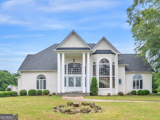 474 N Rover Rd, Williamson, GA 30292 - greek revival house featuring a front lawn, french doors, roof with shingles, and stucco siding