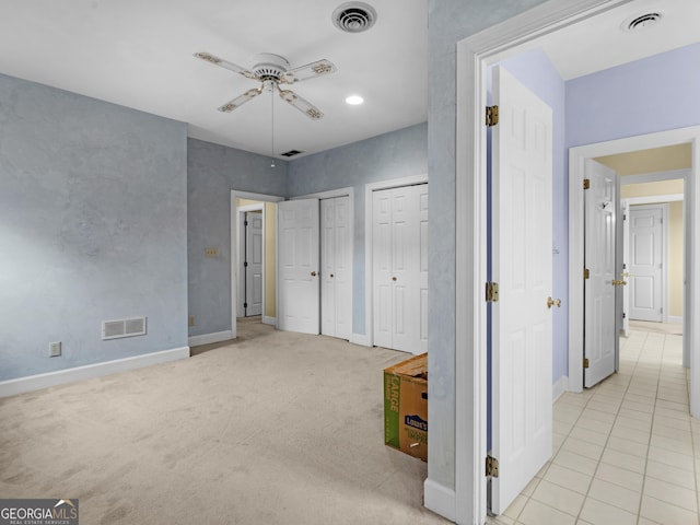474 N Rover Rd, Williamson, GA 30292 - unfurnished bedroom with two closets, baseboards, a ceiling fan, and tile patterned flooring