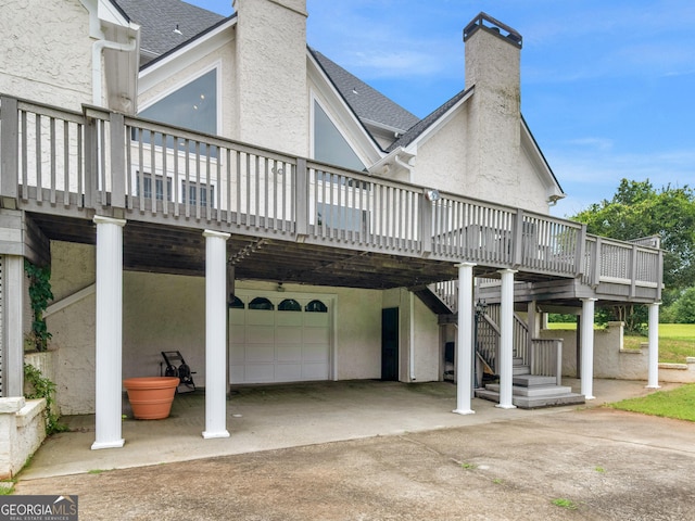 474 N Rover Rd, Williamson, GA 30292 - back of property with an attached garage, a chimney, a deck, and stucco siding