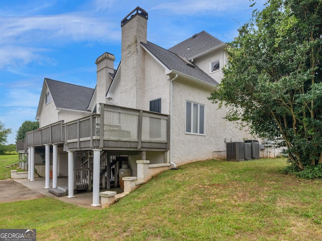 474 N Rover Rd, Williamson, GA 30292 - back of house with a chimney, a patio area, a wooden deck, central AC unit, and a yard