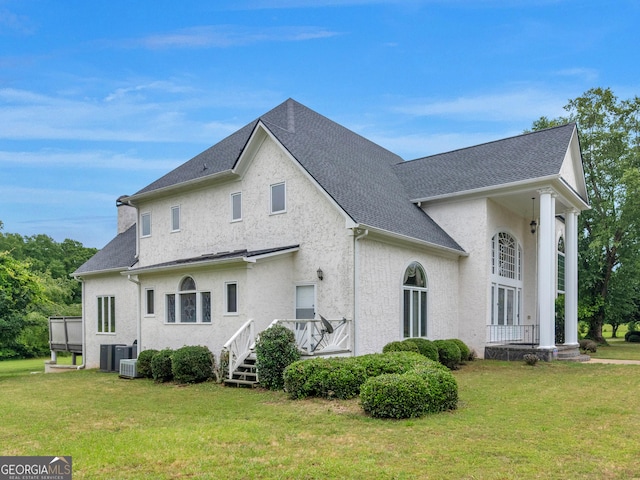474 N Rover Rd, Williamson, GA 30292 - view of side of property featuring a lawn, stucco siding, a shingled roof, and central AC unit