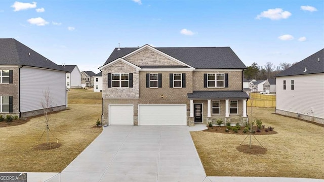 1159 Blue Juniper Cir, Loganville, GA 30052 - view of front of home with a garage, driveway, stone siding, a front lawn, and brick siding