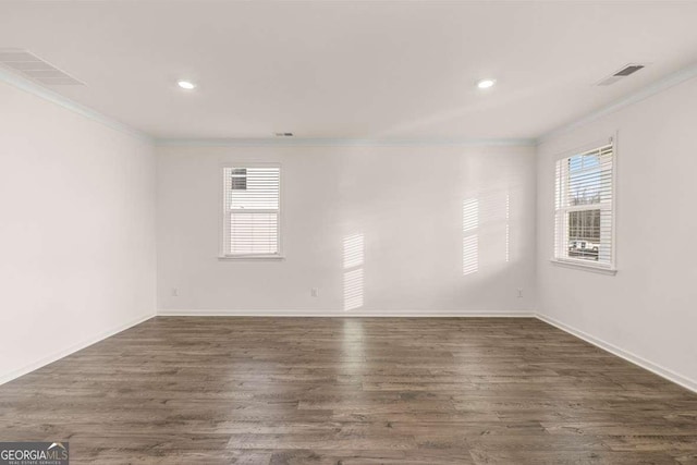 1159 Blue Juniper Cir, Loganville, GA 30052 - unfurnished room featuring ornamental molding, baseboards, dark wood-type flooring, and recessed lighting
