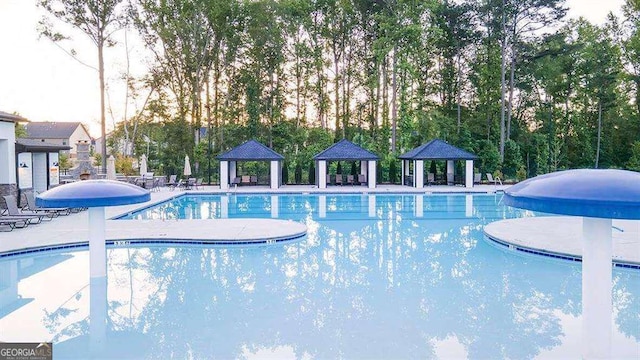 1159 Blue Juniper Cir, Loganville, GA 30052 - community pool featuring a gazebo and a patio area