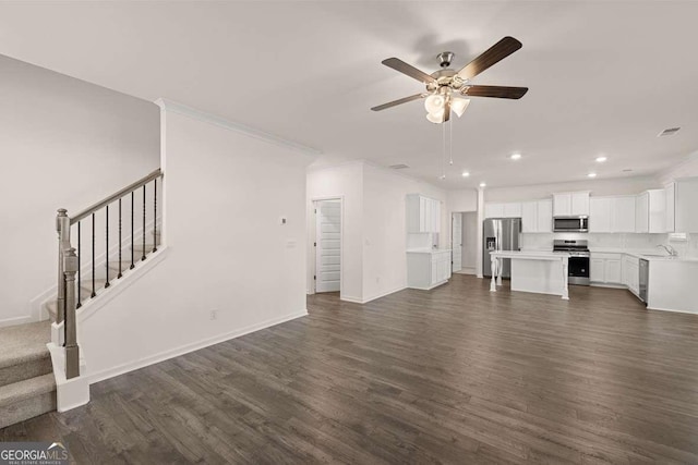 1159 Blue Juniper Cir, Loganville, GA 30052 - unfurnished living room with recessed lighting, a ceiling fan, dark wood finished floors, a sink, and stairs