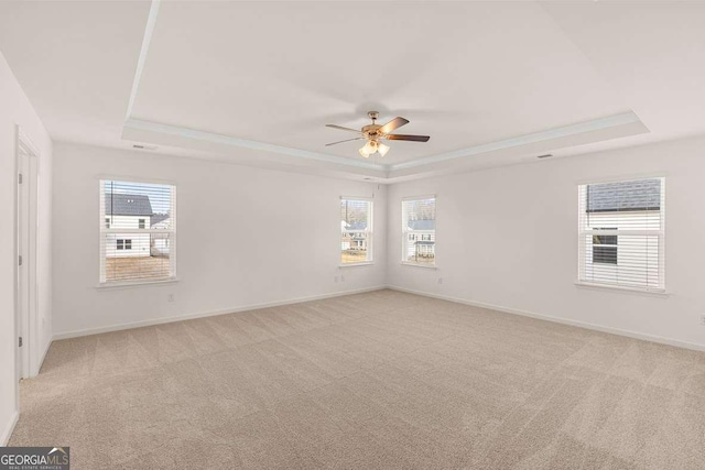 1159 Blue Juniper Cir, Loganville, GA 30052 - unfurnished room featuring a raised ceiling, light colored carpet, a ceiling fan, and baseboards