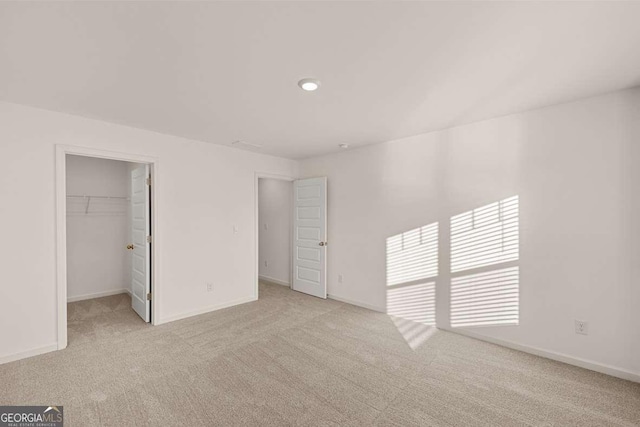 1159 Blue Juniper Cir, Loganville, GA 30052 - unfurnished bedroom featuring carpet floors, a walk in closet, baseboards, recessed lighting, and a closet
