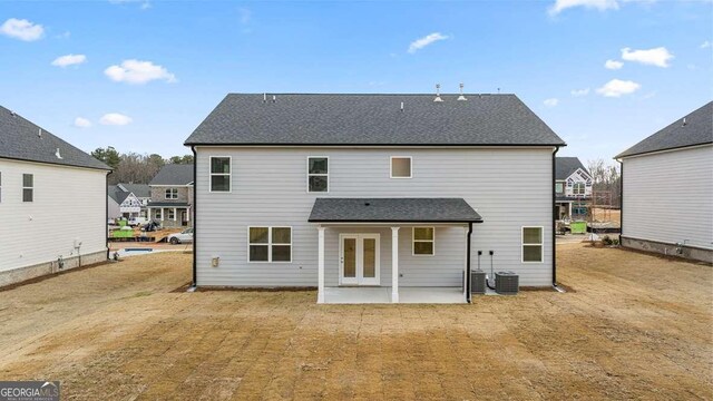 1159 Blue Juniper Cir, Loganville, GA 30052 - back of property featuring a patio and roof with shingles