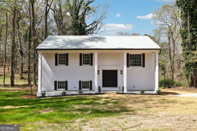 1483 Madison Rd, Monticello, GA 31064 - split foyer home featuring brick siding, metal roof, a front yard, and covered porch