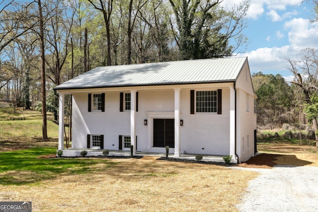 1483 Madison Rd, Monticello, GA 31064 - split foyer home featuring brick siding, metal roof, and covered porch