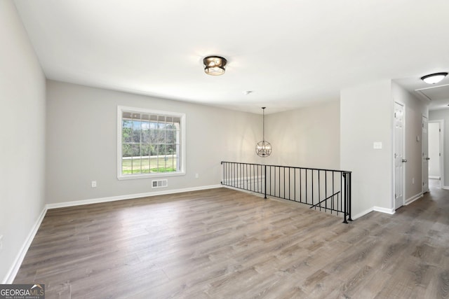 1483 Madison Rd, Monticello, GA 31064 - unfurnished room featuring wood finished floors, a chandelier, and baseboards