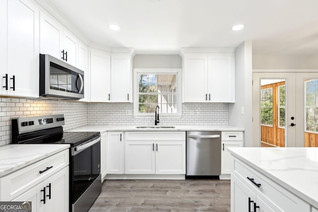 1483 Madison Rd, Monticello, GA 31064 - kitchen featuring appliances with stainless steel finishes, a sink, plenty of natural light, decorative backsplash, and recessed lighting
