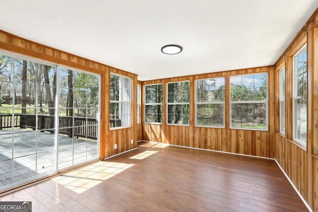 1483 Madison Rd, Monticello, GA 31064 - unfurnished sunroom with hardwood / wood-style floors, healthy amount of natural light, wooden walls, and baseboards