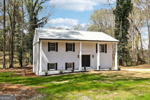 1483 Madison Rd, Monticello, GA 31064 - raised ranch featuring brick siding, a front lawn, and covered porch