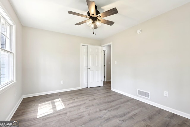 1483 Madison Rd, Monticello, GA 31064 - spare room with healthy amount of natural light, a ceiling fan, wood finished floors, and baseboards