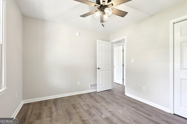 1483 Madison Rd, Monticello, GA 31064 - unfurnished bedroom featuring wood finished floors, baseboards, and ceiling fan