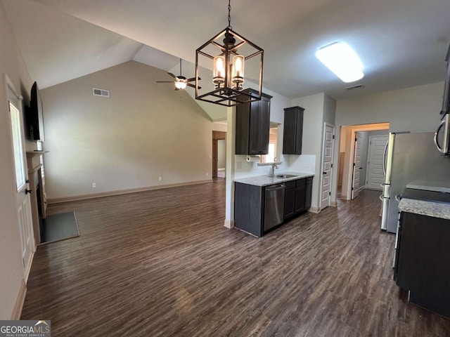 1010 Holliday Pass, Griffin, GA 30223 - kitchen featuring stainless steel appliances, a sink, a ceiling fan, dark wood-style flooring, and vaulted ceiling