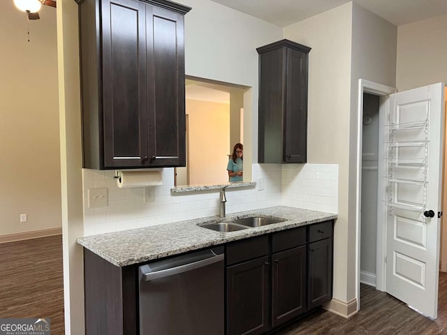 1010 Holliday Pass, Griffin, GA 30223 - kitchen featuring stainless steel dishwasher, a sink, dark wood-style floors, backsplash, and baseboards