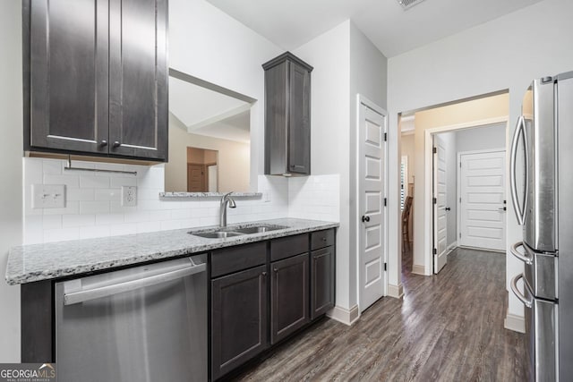 1010 Holliday Pass, Griffin, GA 30223 - kitchen with stainless steel appliances, dark wood-style flooring, light stone countertops, and backsplash