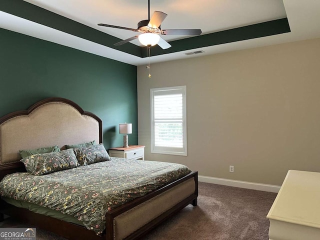 1010 Holliday Pass, Griffin, GA 30223 - carpeted bedroom featuring baseboards, ceiling fan, and a raised ceiling