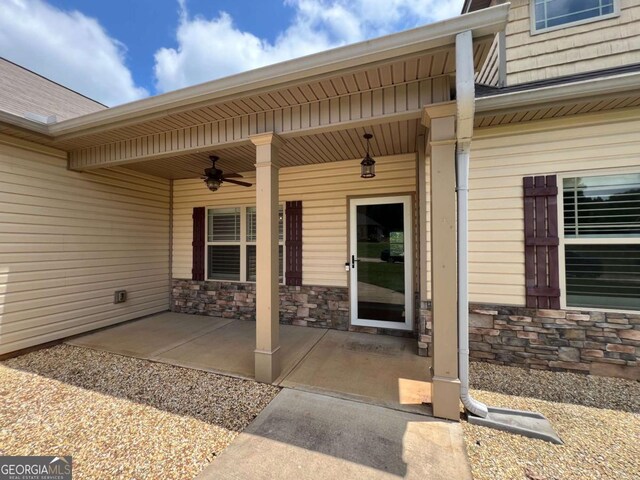 1010 Holliday Pass, Griffin, GA 30223 - entrance to property with a ceiling fan and stone siding