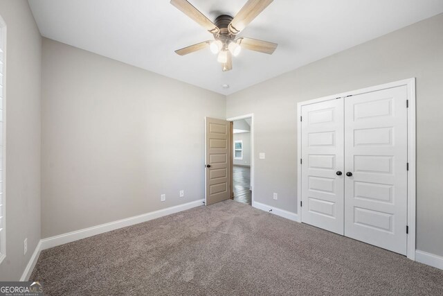 1010 Holliday Pass, Griffin, GA 30223 - unfurnished bedroom featuring carpet flooring, a closet, and ceiling fan