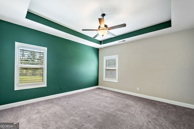 1010 Holliday Pass, Griffin, GA 30223 - carpeted spare room featuring plenty of natural light, a ceiling fan, and a raised ceiling