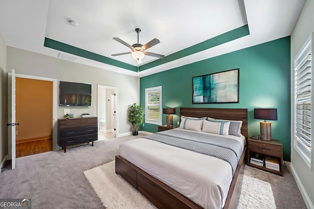 1010 Holliday Pass, Griffin, GA 30223 - bedroom featuring a raised ceiling, carpet, multiple windows, and ceiling fan