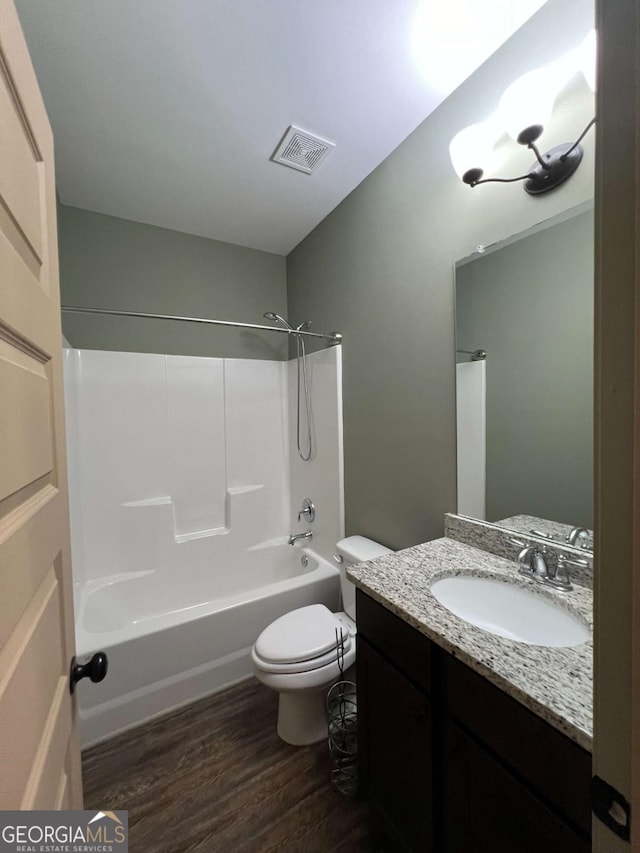 1010 Holliday Pass, Griffin, GA 30223 - full bath with vanity, wood finished floors, shower / bathtub combination, and toilet