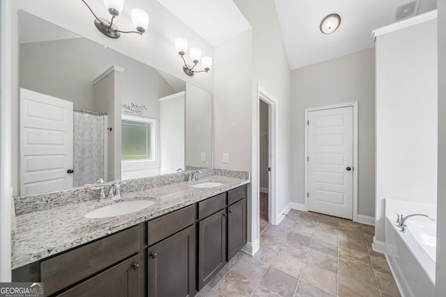 1010 Holliday Pass, Griffin, GA 30223 - bathroom with lofted ceiling, double vanity, a bath, a closet, and stone finish flooring