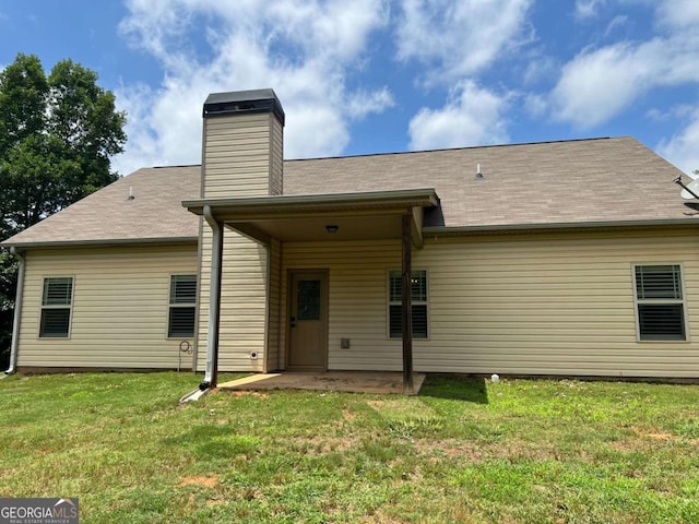 1010 Holliday Pass, Griffin, GA 30223 - rear view of house featuring a patio, a yard, a chimney, and roof with shingles